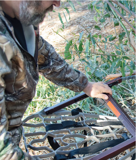 The author prepares to use his climbing tree stand during a recent scouting trip to Southern California in advance of deer season, which starts in many zones this month. (ALBERT QUACKENBUSH)