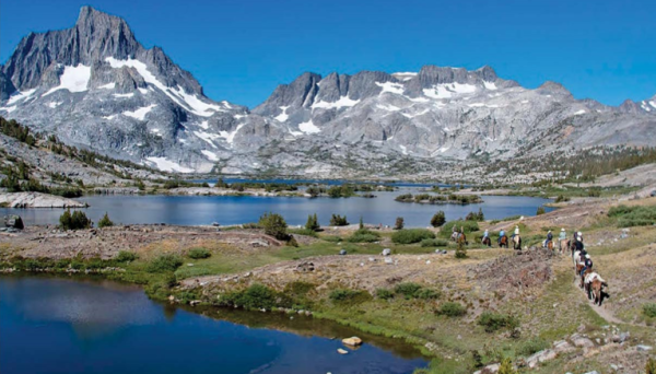 A packtrain transports horse riders and their gear into the spectacular, lake-rich high country of the Eastern Sierras. (FRONTIER PACK STATION)