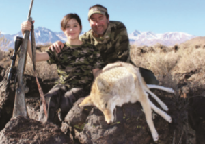 Author with his daughter and her shot coyote.